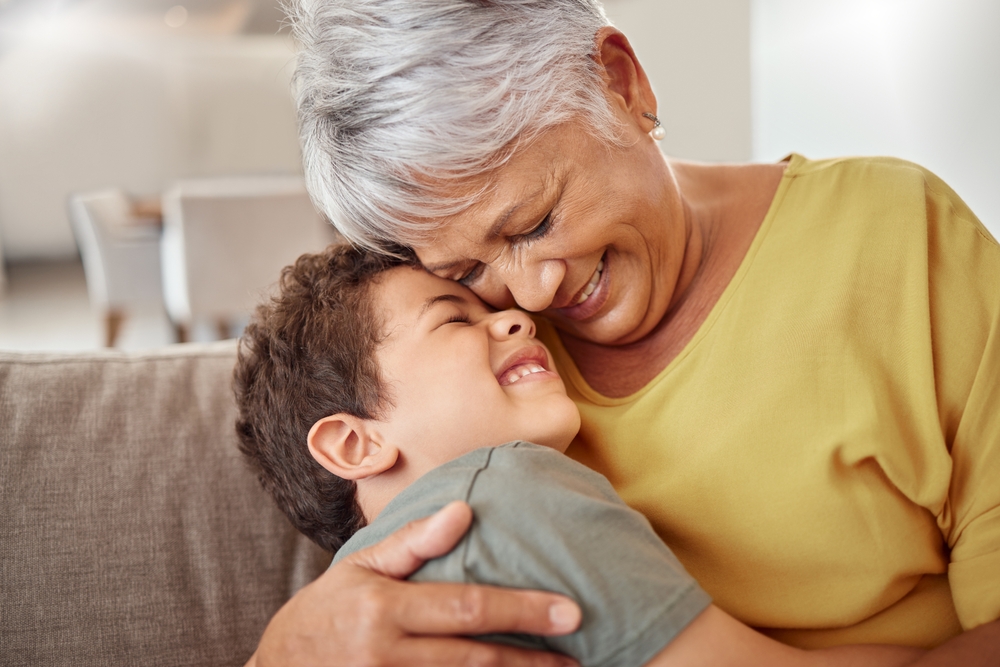 A grandmother hugging her young grandson