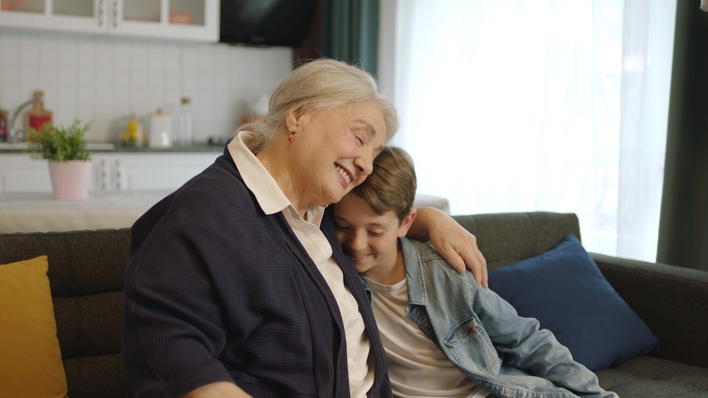 A grandmother hugging her grandson