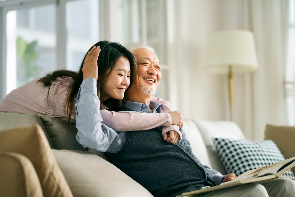 An Asian adult daughter and her senior father