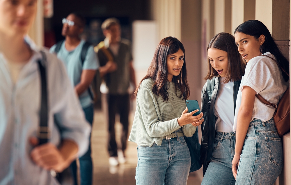 Two fake friends checking out a gossip on phone