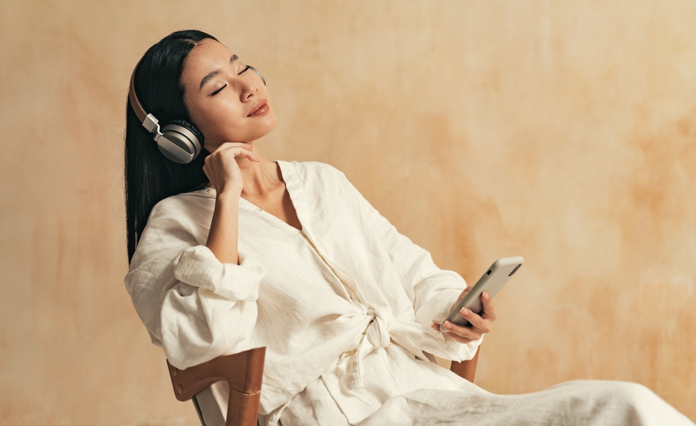 Woman listening to music through her headphones.