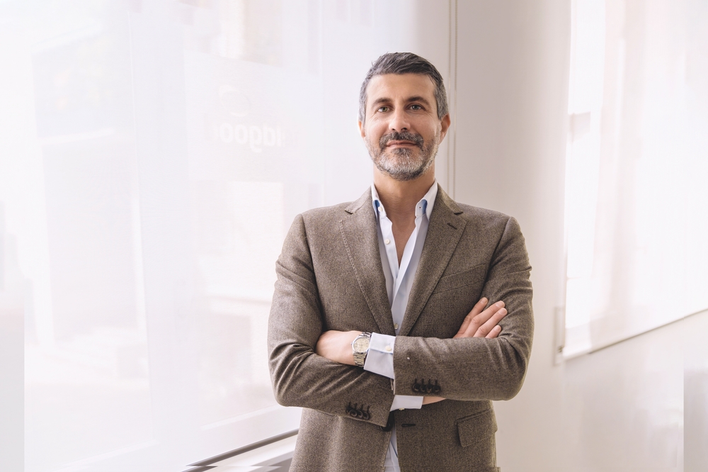 A confident businessman in suit with arms folded