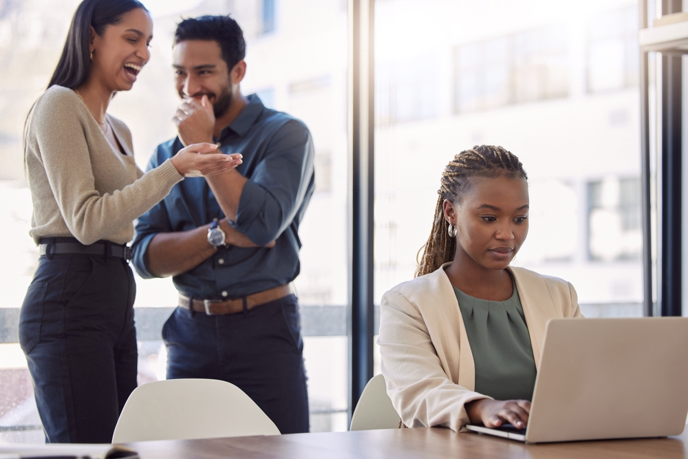 Office bullies, a man and a woman bullying their female colleague
