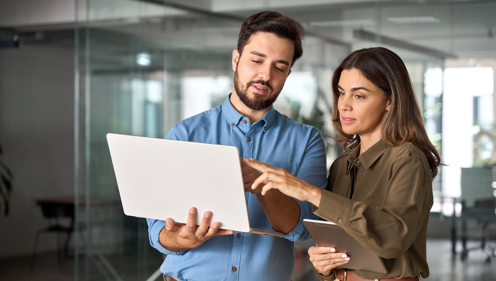 A busy male and female business colleague working together