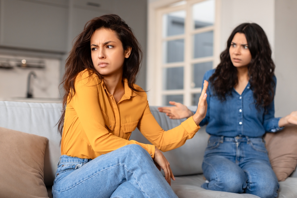 Two Young Ladies Engage,In,A,Tense,Conversation