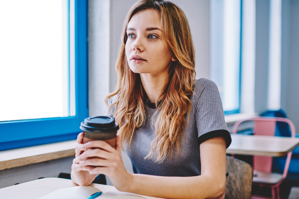 Female college student sitting in classroom.
