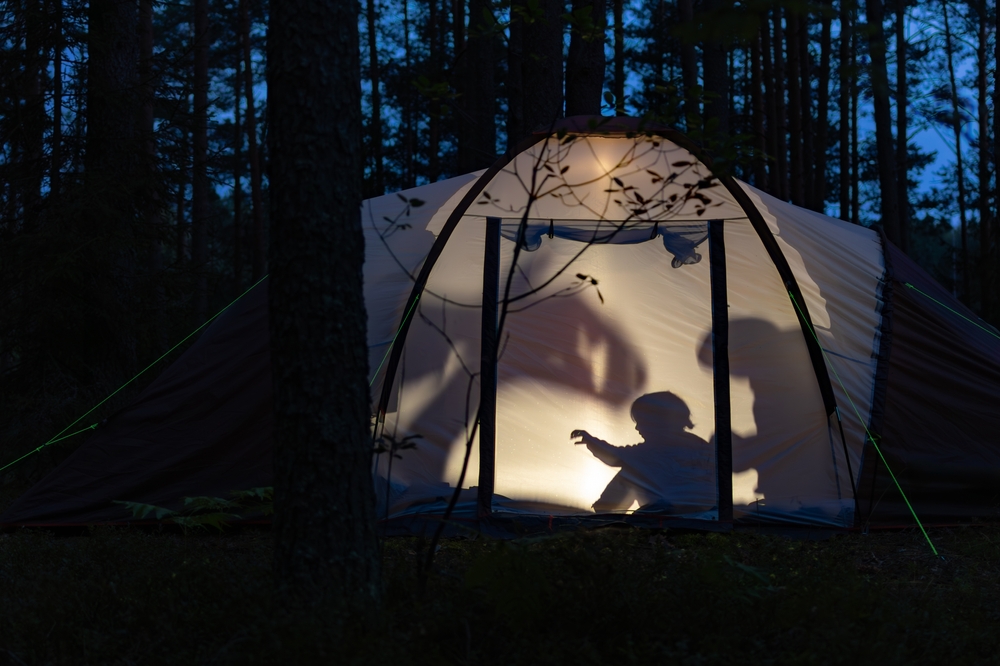 Children in a tent at night.
