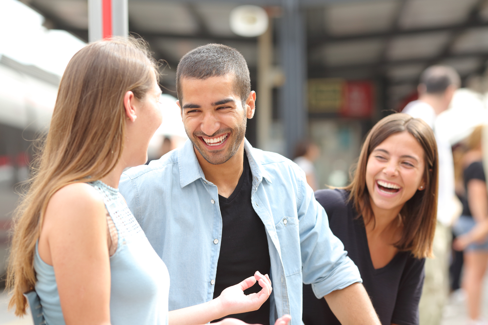 Three friends talking and laughing and having fun with each other