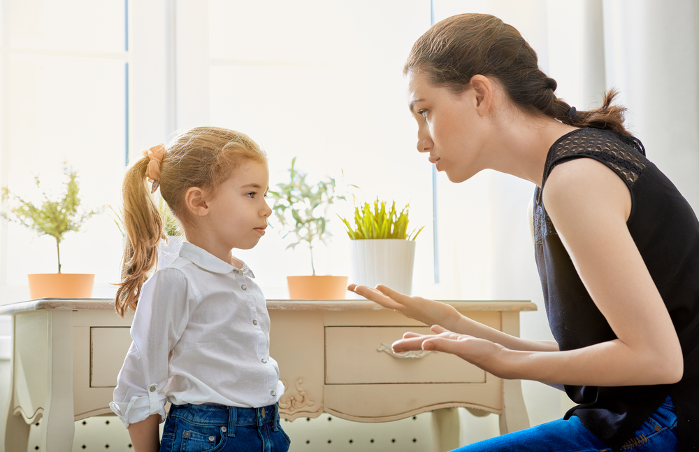 A mother scolds her young female child