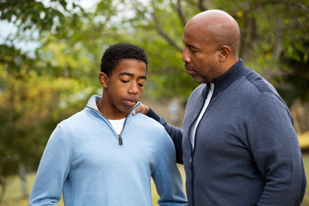 African American father parenting his teenage son