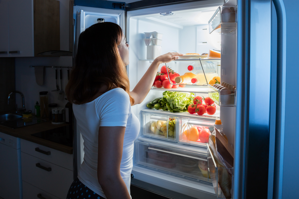 Woman Looking Inside Her Refrigerator.