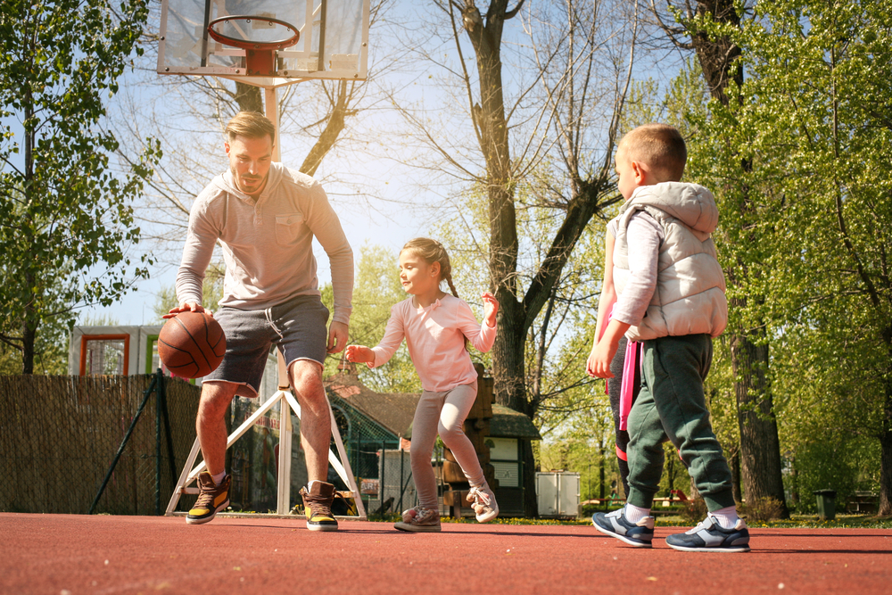 A happy family playing basketball together