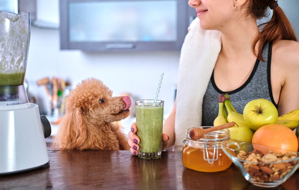 A woman making a healthy smoothie for breakfast.
