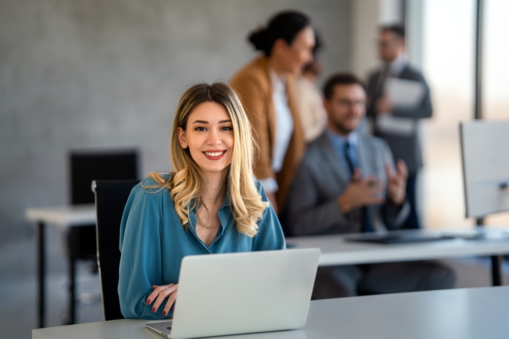 A young happy successful business woman working in her office