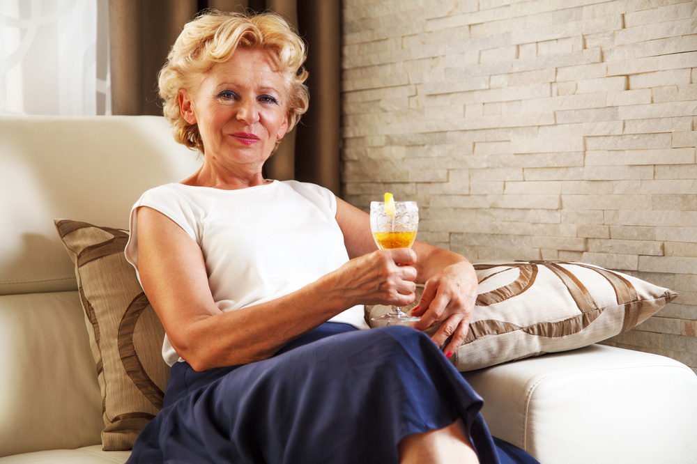 Beautiful senior woman having a drink