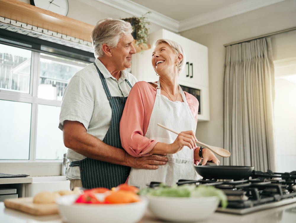 Senior couple cooking and having fun together in the kitchen.