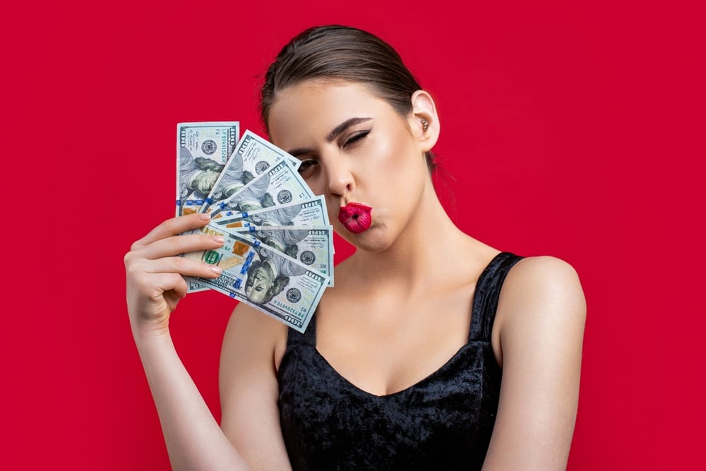 Woman holding up money
