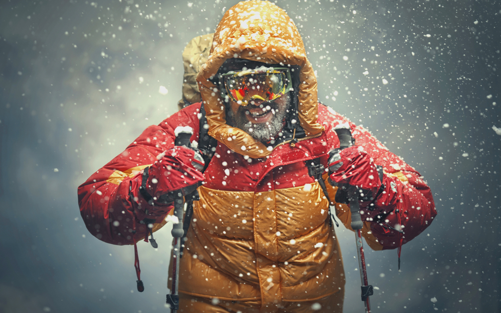 A climber trekking through snow.