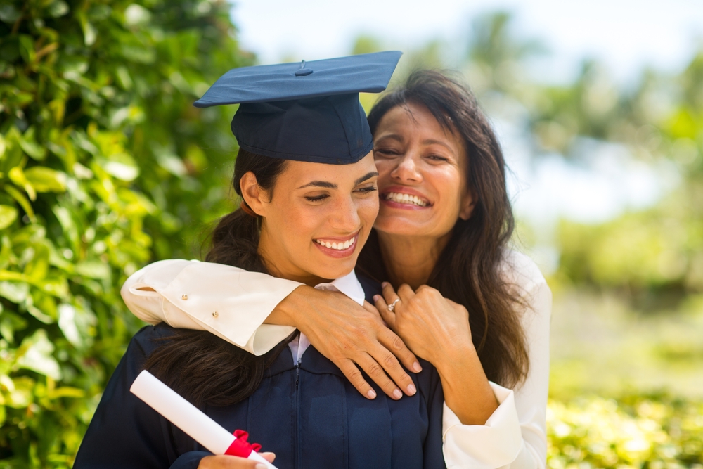 A happy mother hugging her graduating daughter on her graduation day
