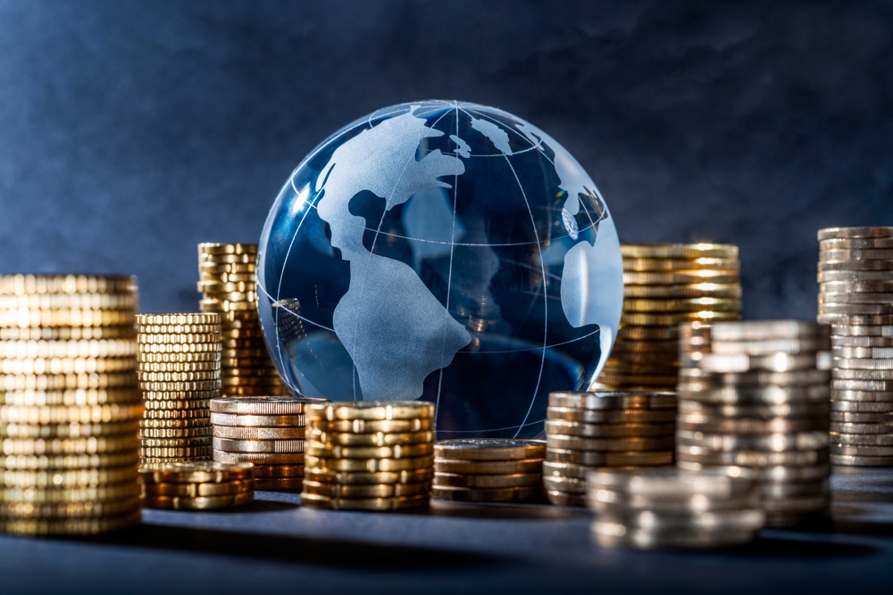 A globe with stacks of coins nearby.