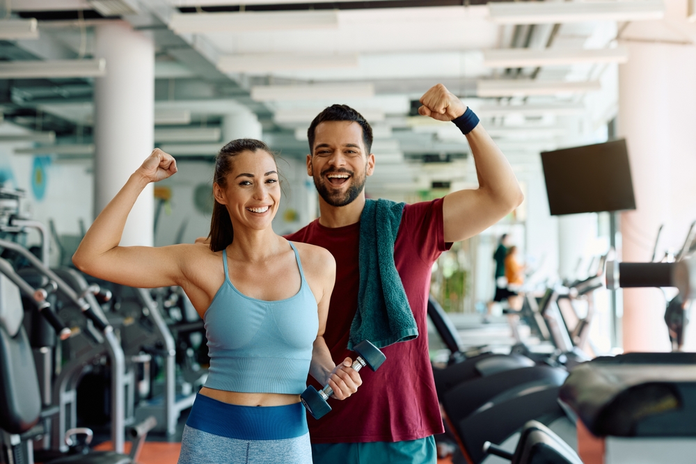 Happy couple at the gym working out