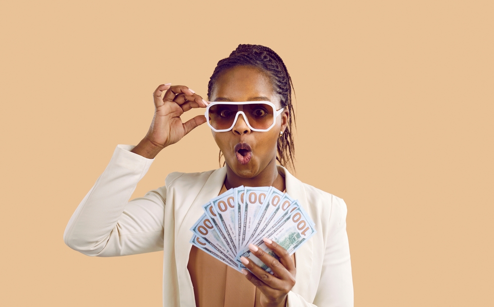 A rich woman holding her cash.