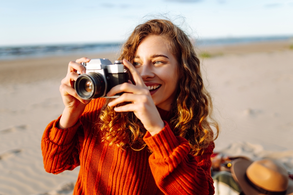 Woman on vacation at the beach taking a photo