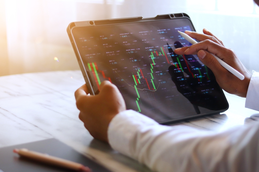 A man checking the stock market on his computer.