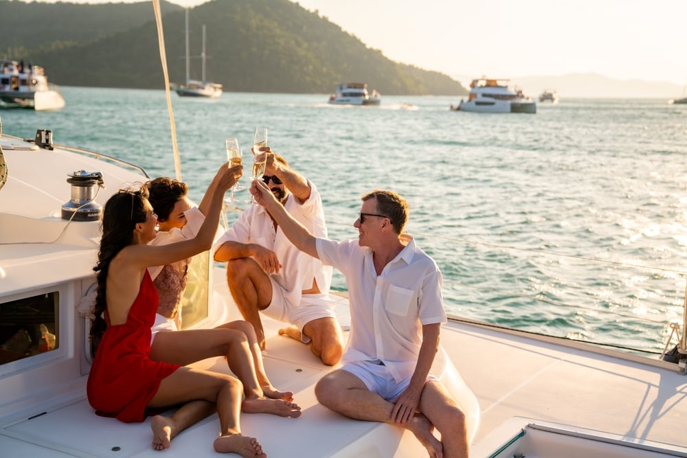 A group of friends out on a boat in the summer