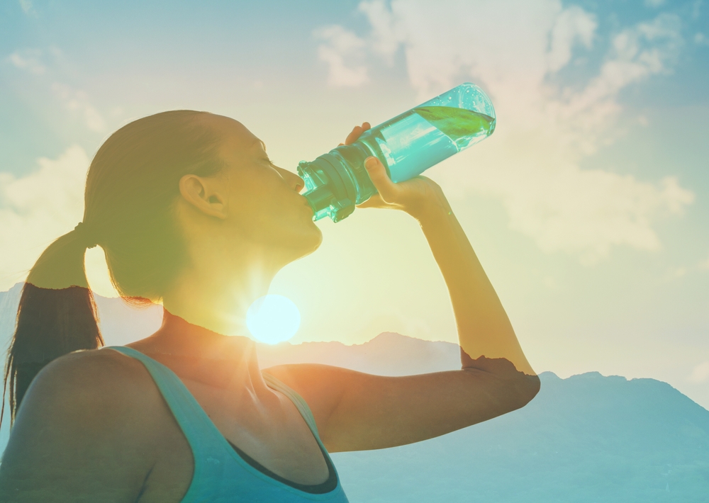 An active woman drinking water on her break from her morning run