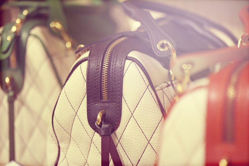 A row of designer handbags.
