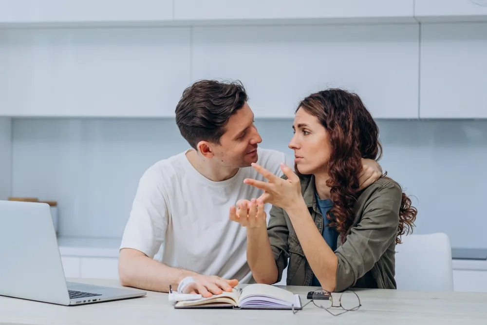 Couple having a tense talk about life, marriage, money