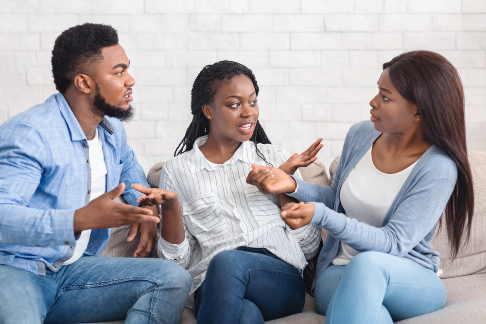 Three young black friends having a friendly discussion