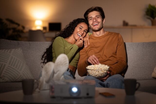 Couple watching tv together.