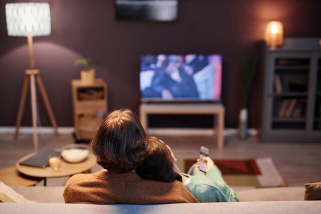 A couple watching TV together.