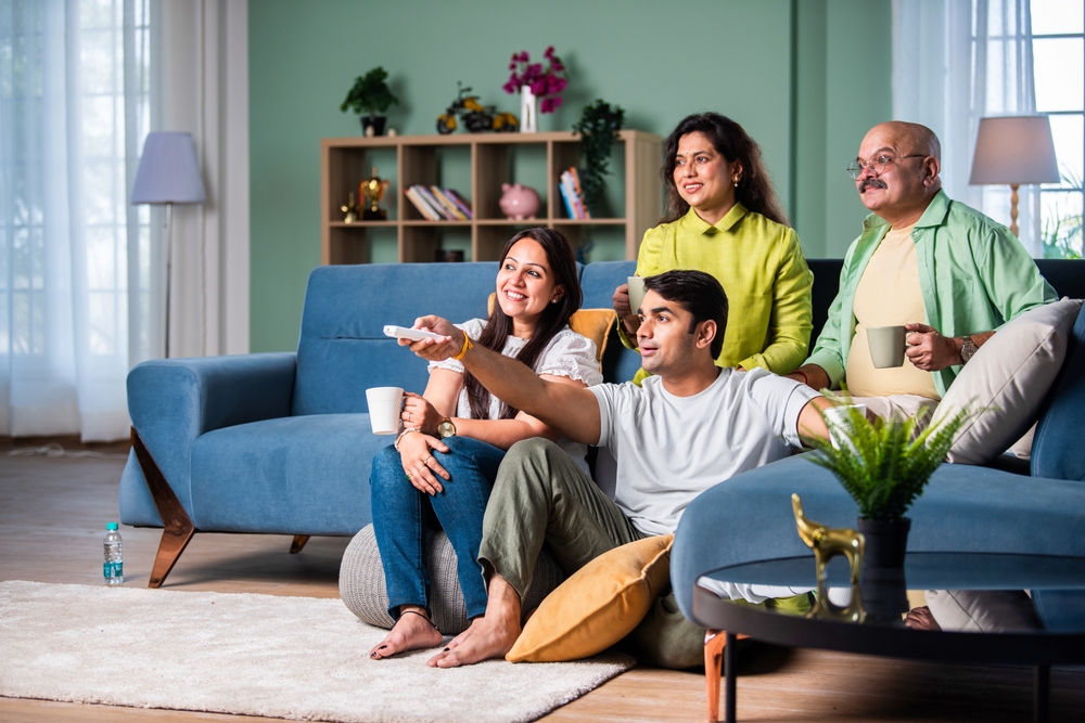 Indian family of four watching cable television