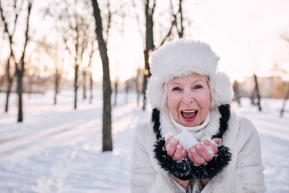 Senior woman walking in the snow.