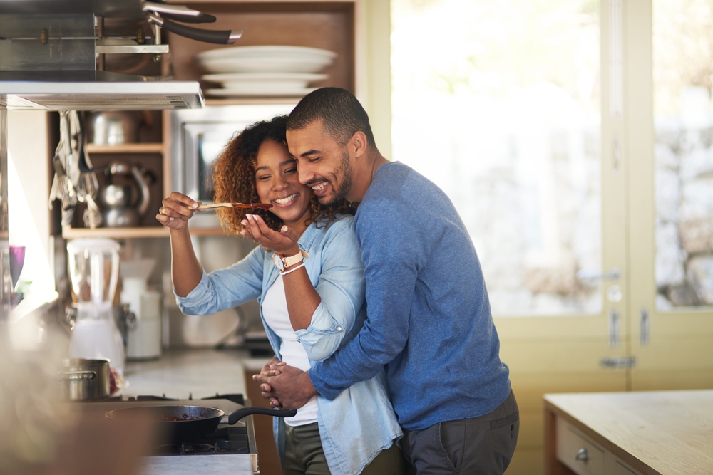 A happy couple in love making dinner together