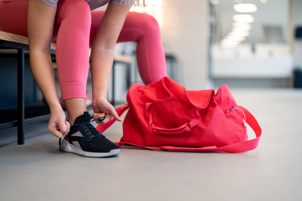 Woman in athletic gym gear getting ready to work out.
