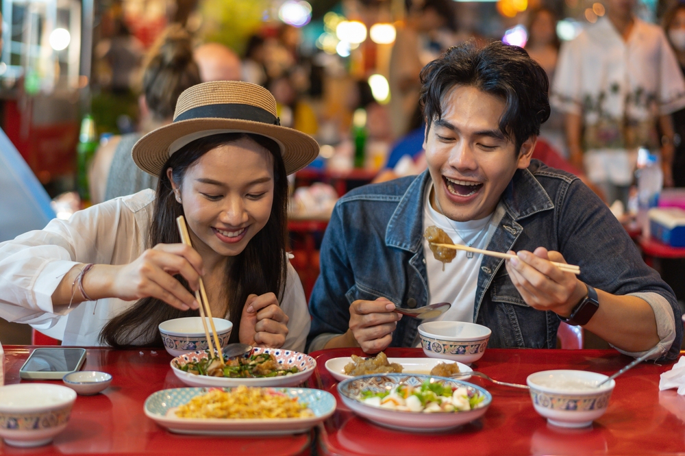 Young Asian couple sharing a meal at a restaurant