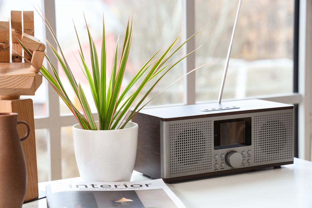 A radio in a kitchen window.