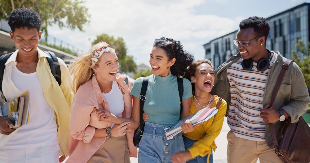 A group of young friends walking and laughing on their way to class