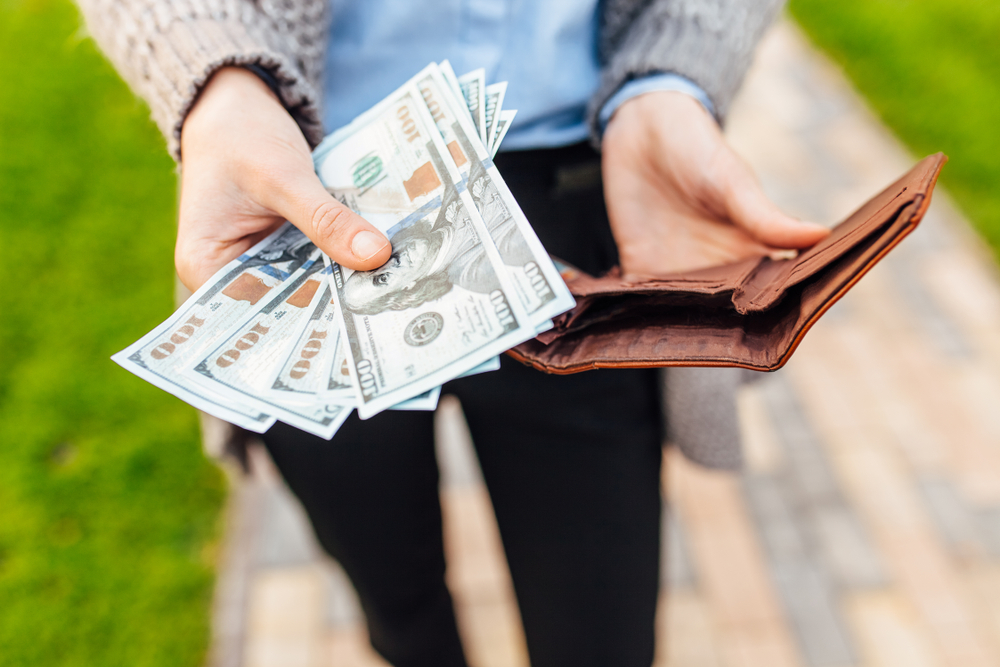 A woman with money in her wallet.