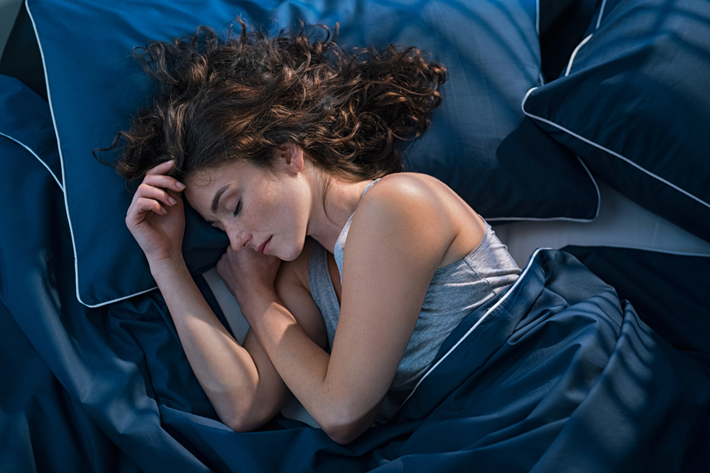A young woman sleeping in her bed