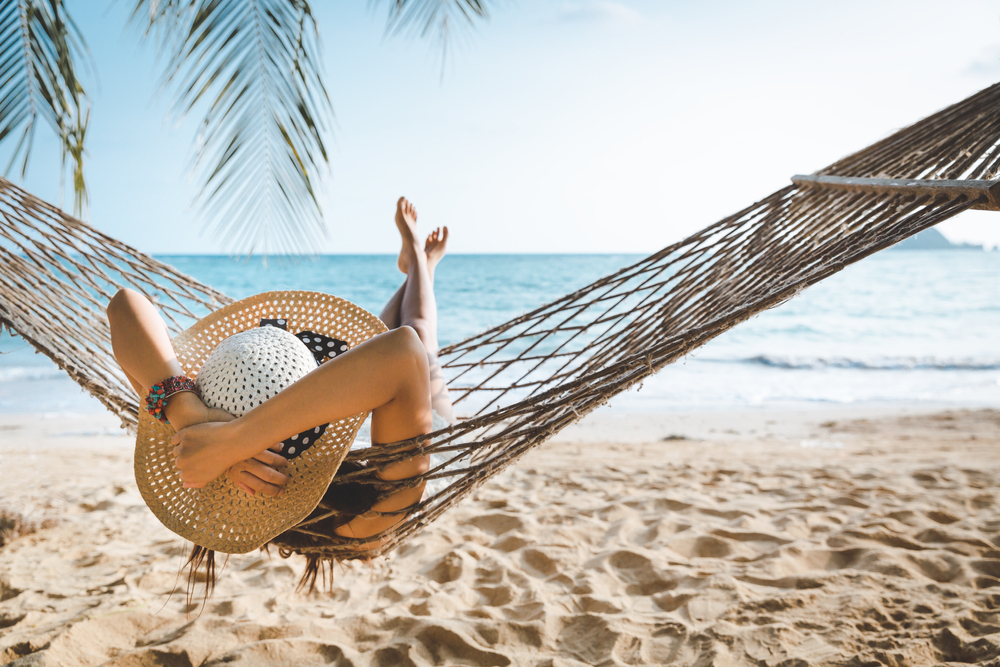 Woman on a beach in a hammock on vacation