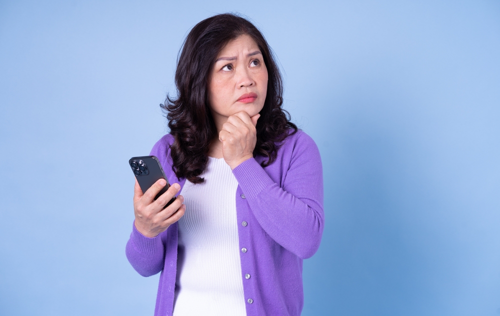 A smart middle aged Asian woman analyzing something in her mind