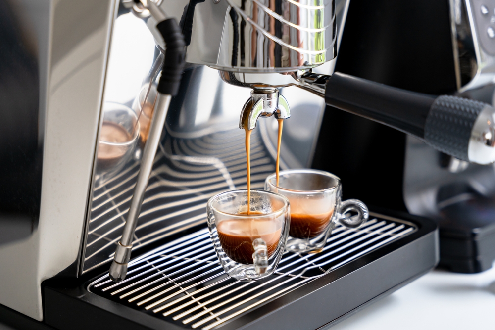 Brewing expresso into two glass cups
