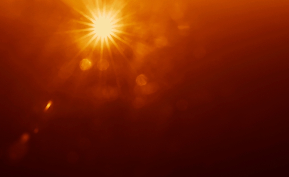 A burst of sunshine in an orange sky.