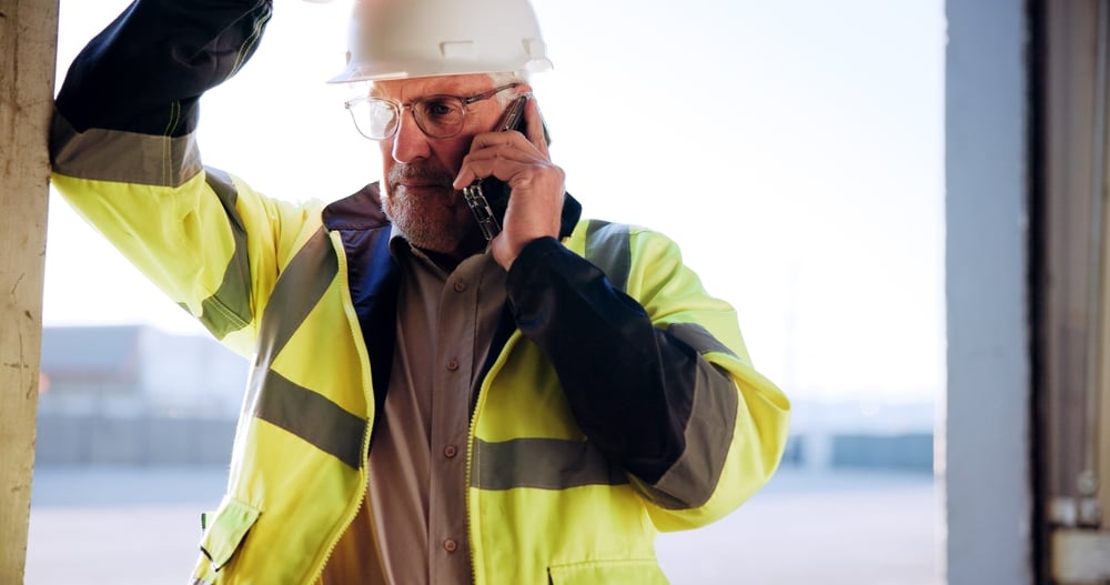 Older man on the phone while taking a break at work.
