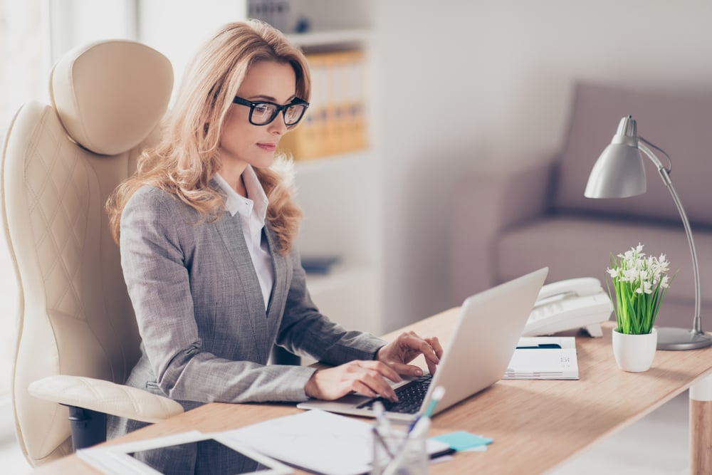 A confident and serious business woman working on her laptop